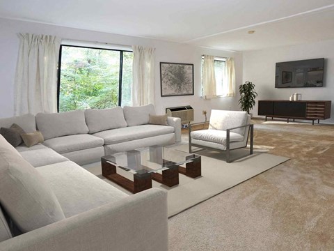 a living room with white couches and a glass coffee table