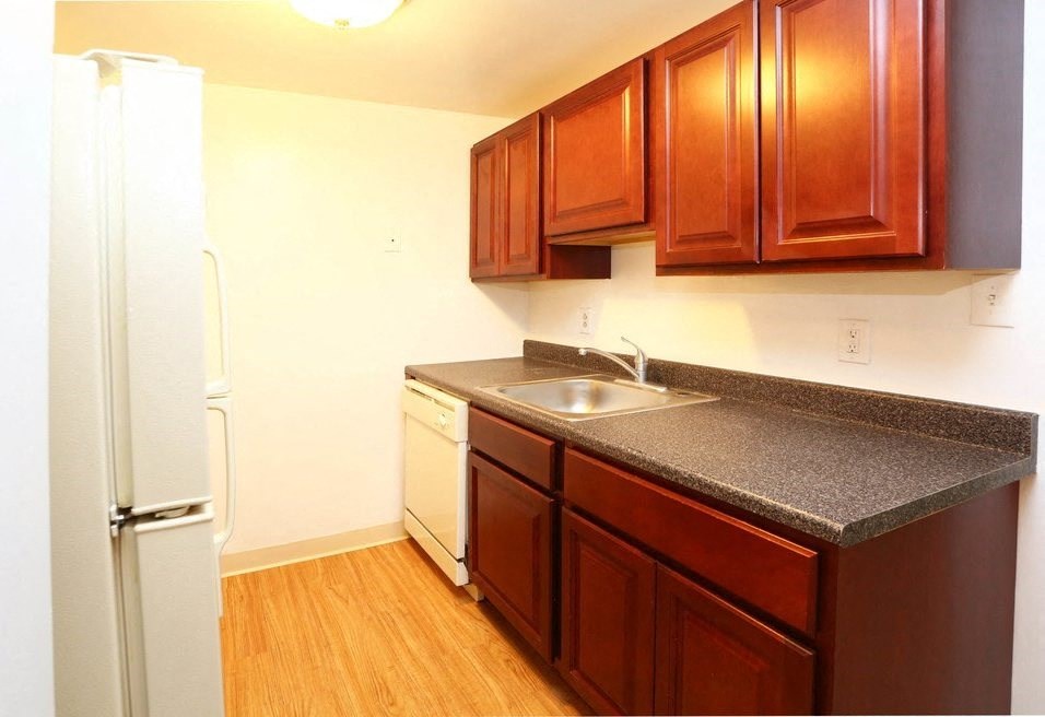 a kitchen with a sink and a refrigerator