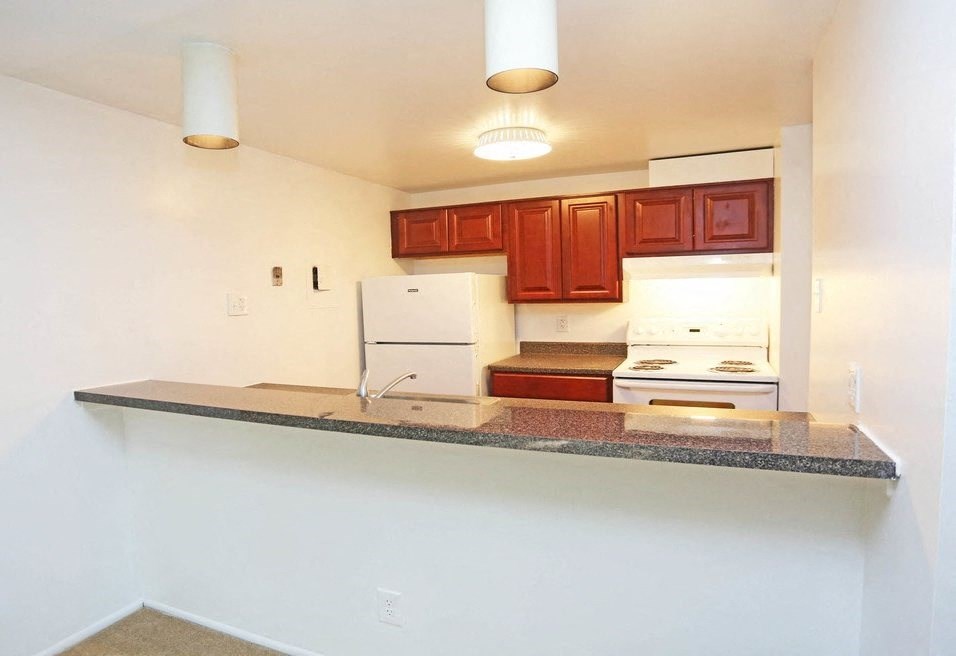 a kitchen with a counter top and a refrigerator