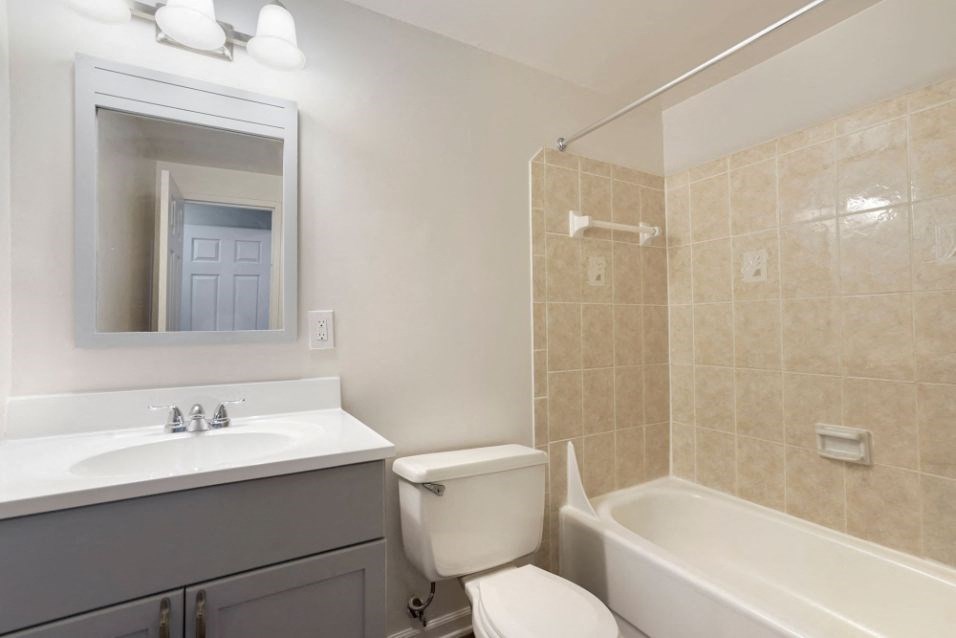 a bathroom with a sink toilet and a bath tub