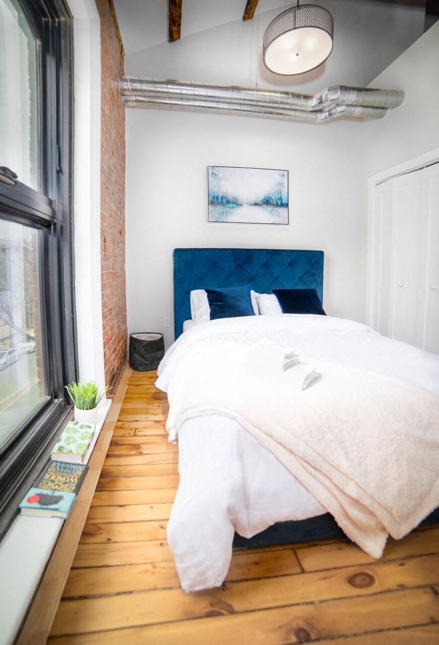 a bedroom with a bed and a window