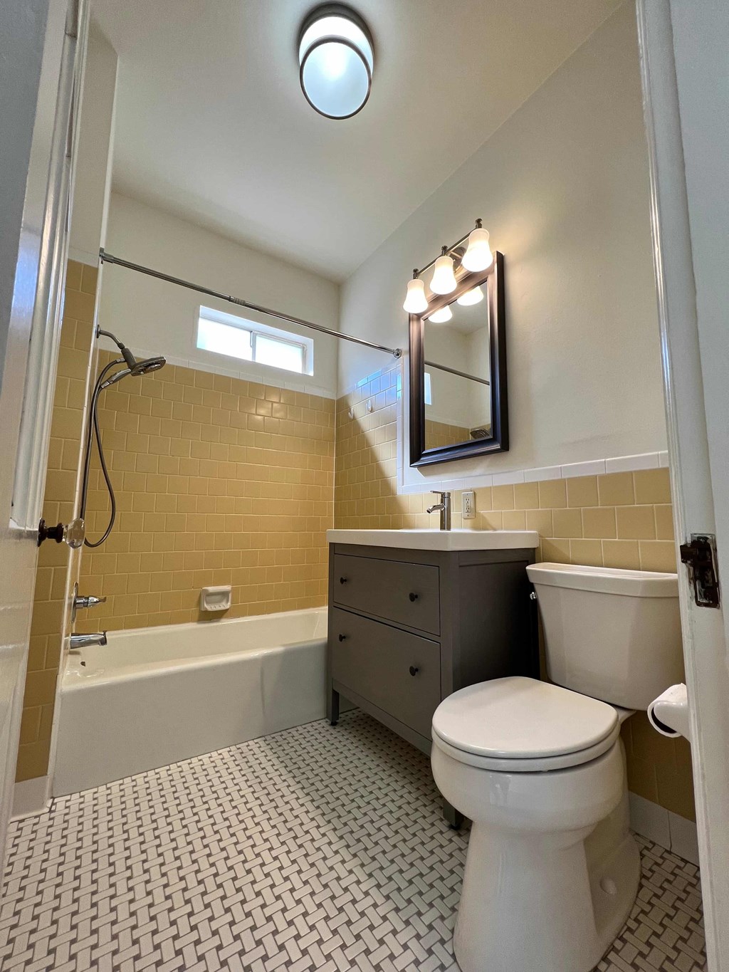 a bathroom with a toilet and a tub and a sink