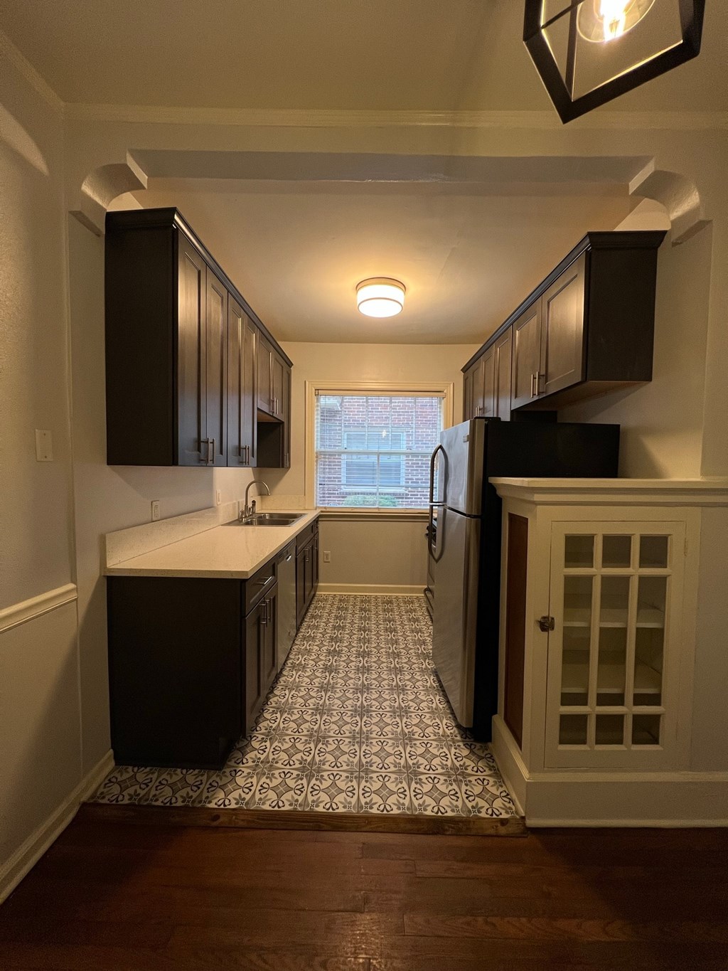 a small kitchen with a sink and a refrigerator