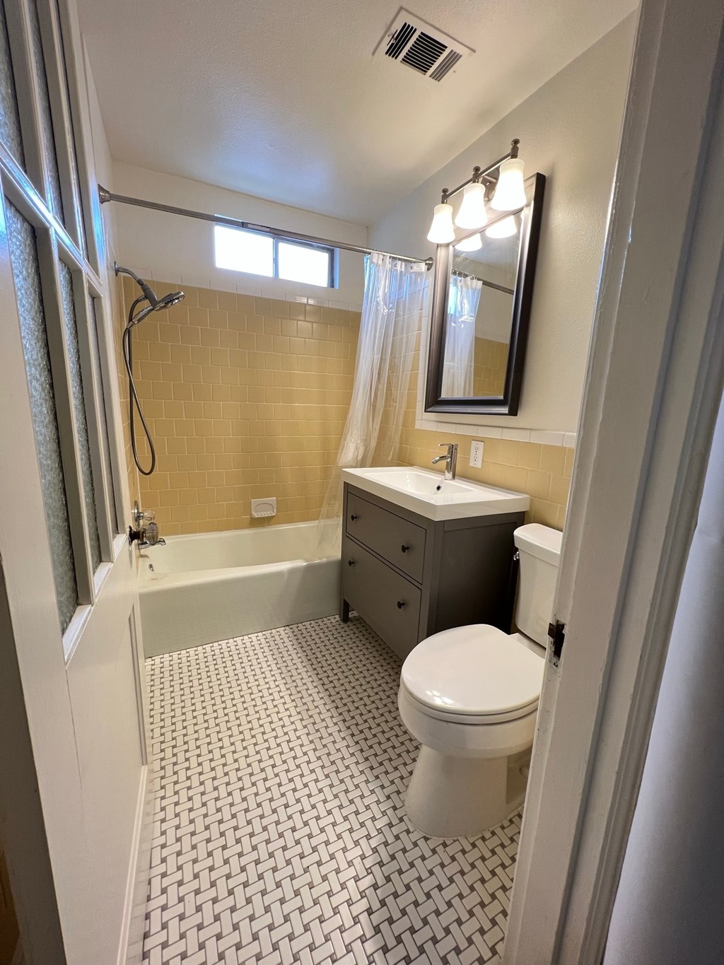 a bathroom with a toilet and a sink and a shower