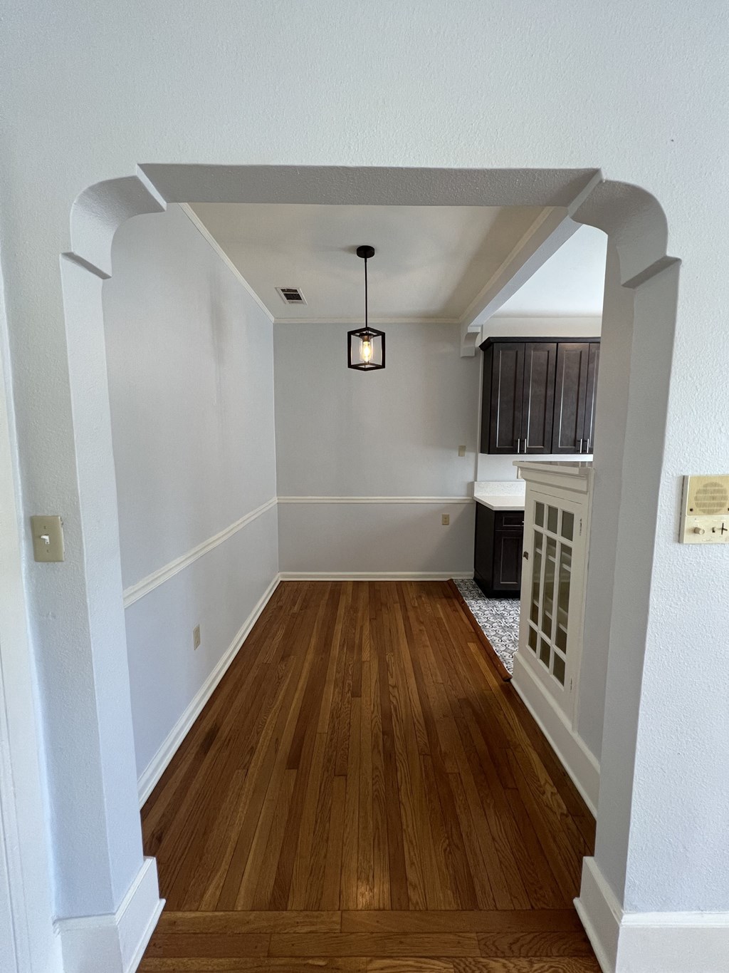 a view from the entryway of a home with wood floors and white walls