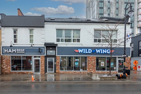 a building with a wild wing sign on the side of a street