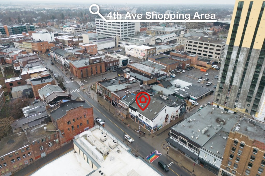 An aerial view of a city with a shopping area located on 4th Ave.
