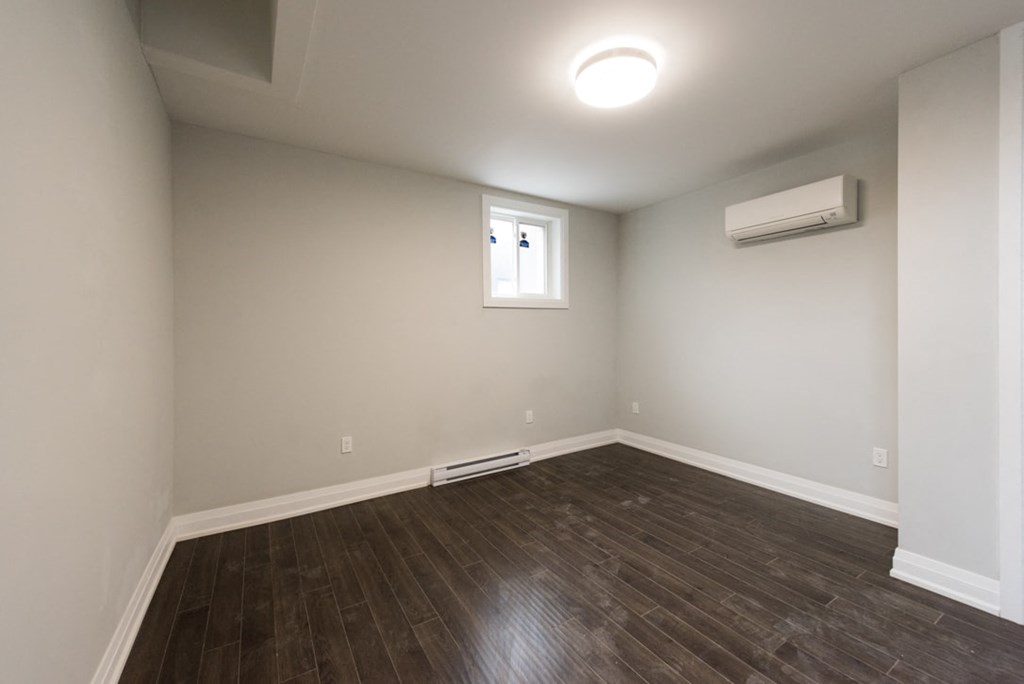 A room with a window and a ceiling light.