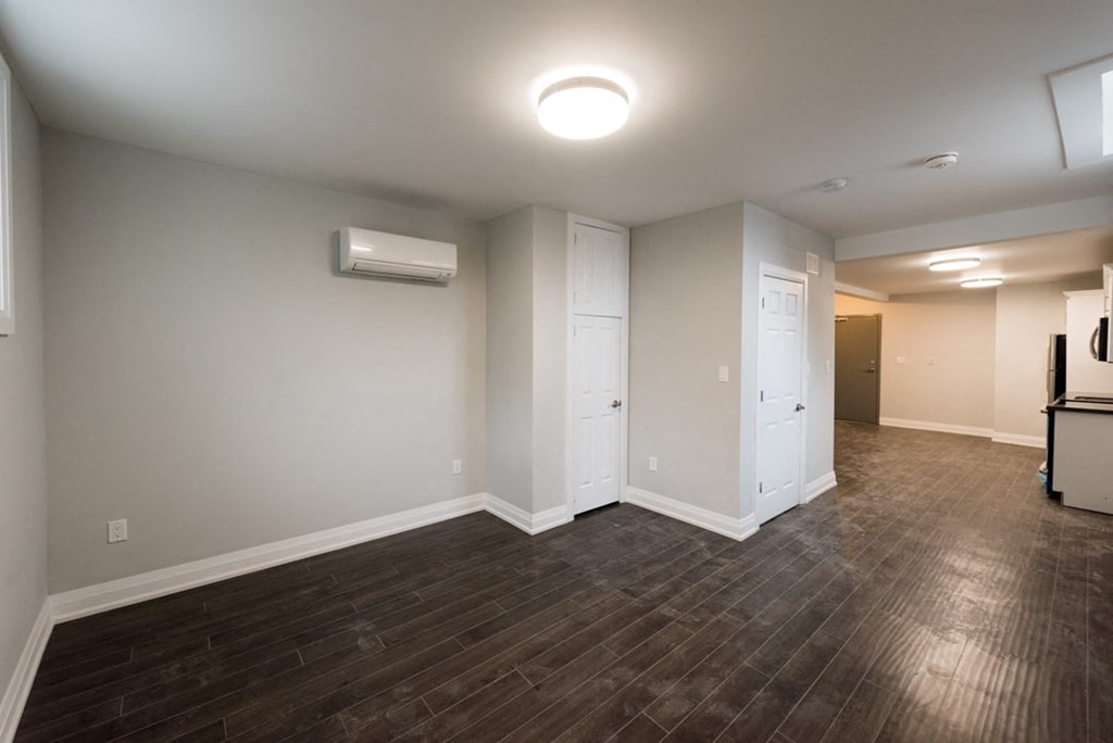A room with a wooden floor and a white ceiling.
