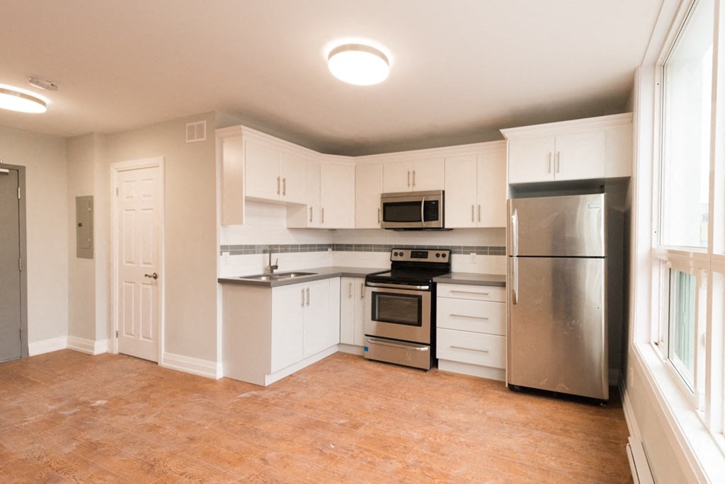 A kitchen with white cabinets and stainless steel appliances.