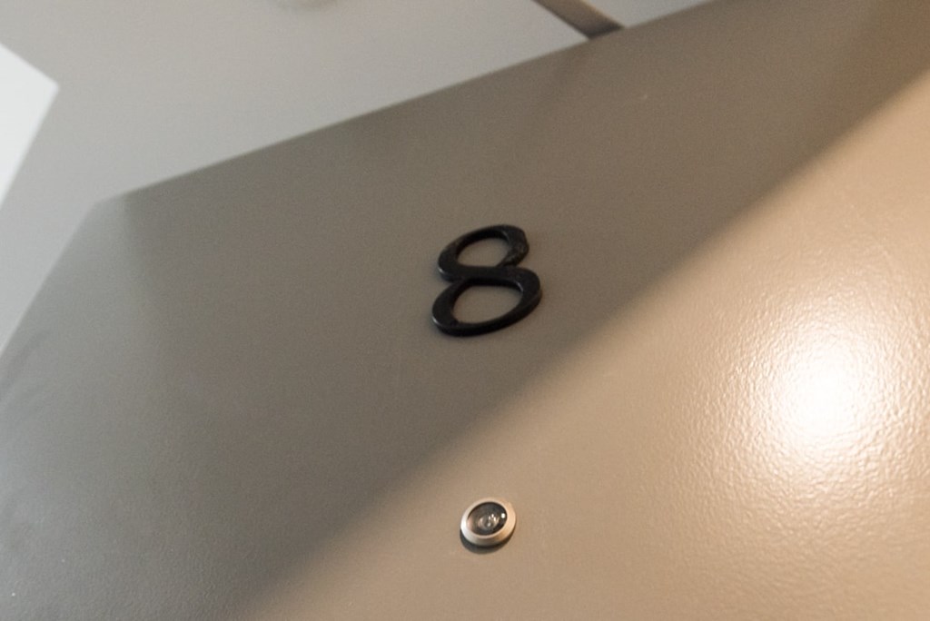 A pair of scissors is placed on a surface with a number 8.
