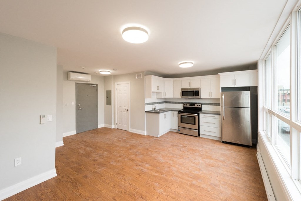 A kitchen with white cabinets and stainless steel appliances.
