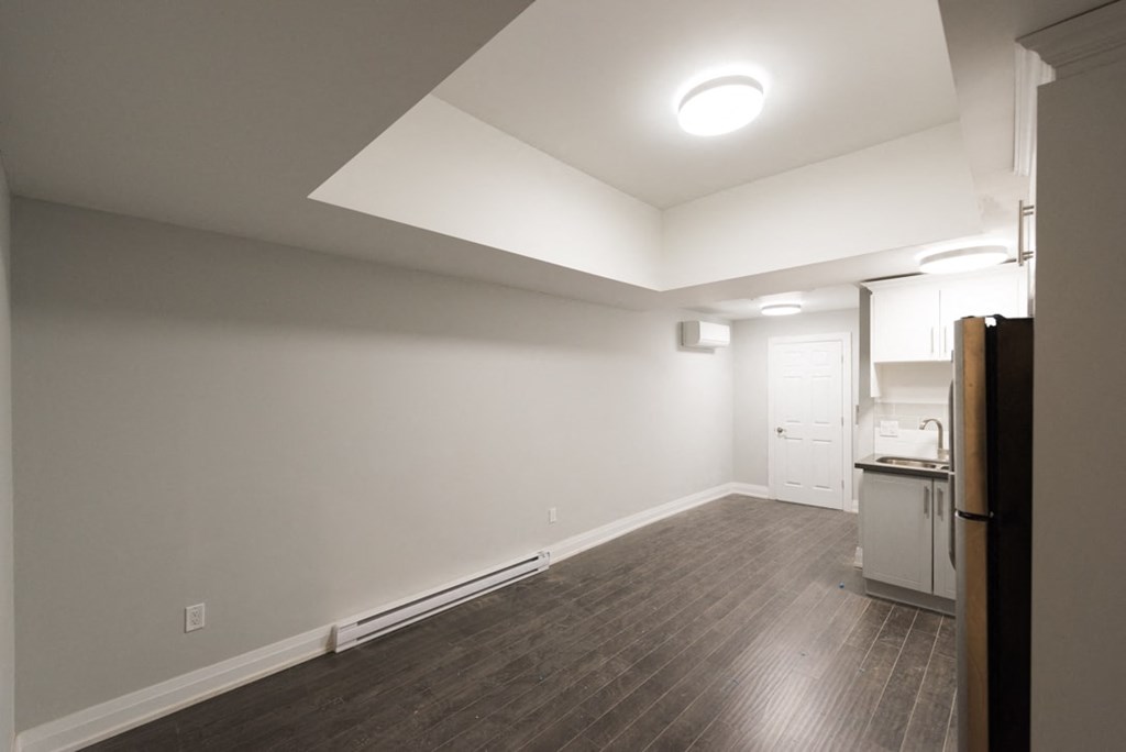 A kitchen area with a refrigerator, oven, and sink.