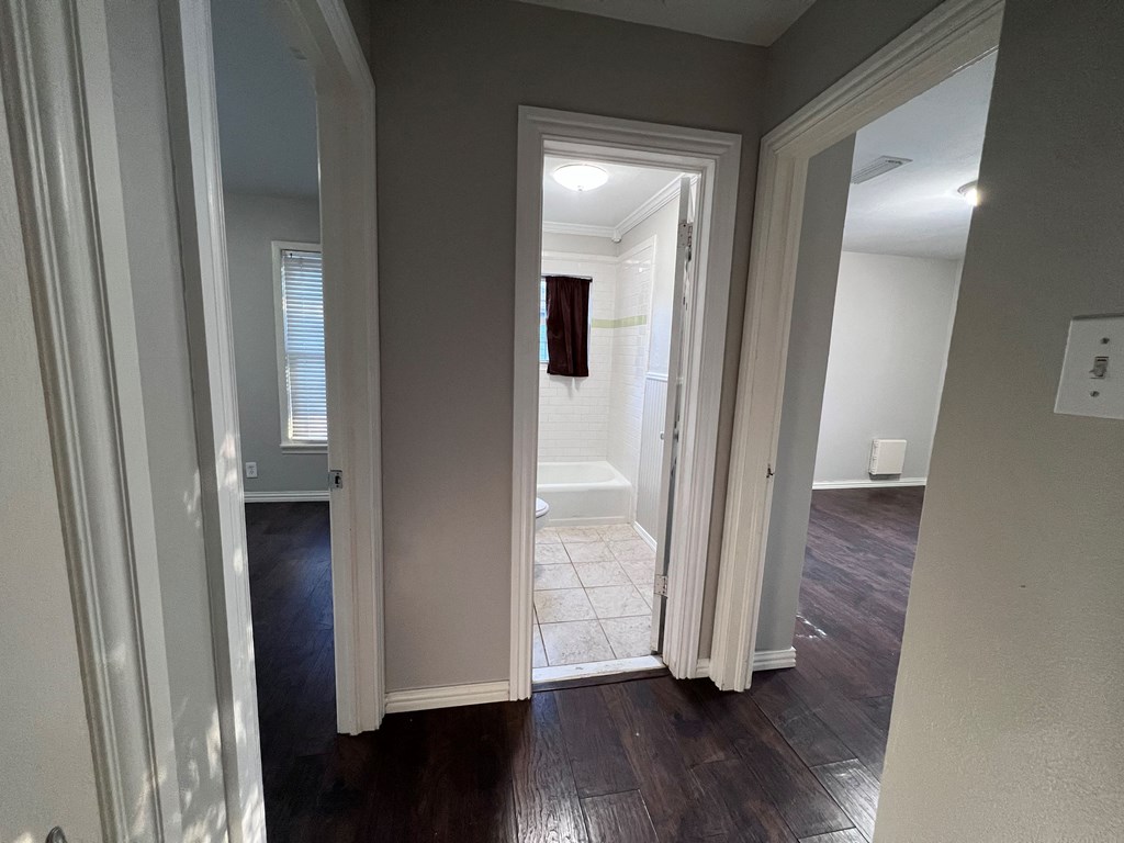 A hallway with a doorway leading to another room.