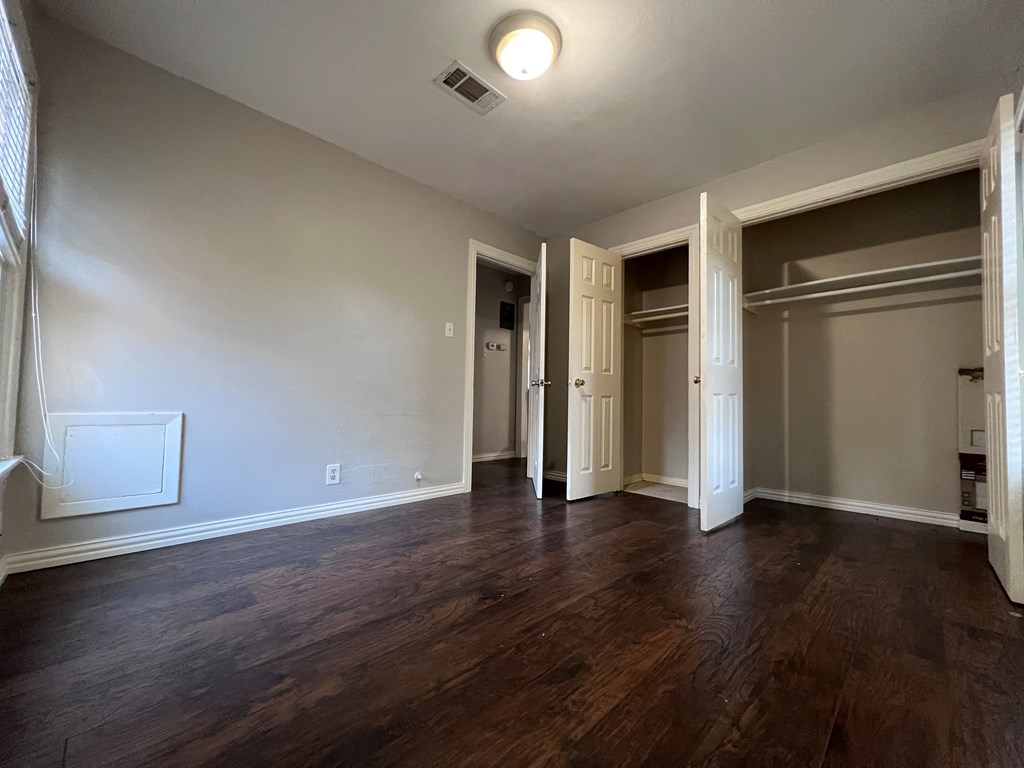 A room with wooden floors and white walls.