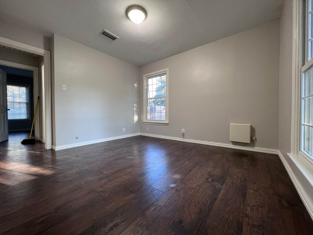 A room with wooden floors and a window.