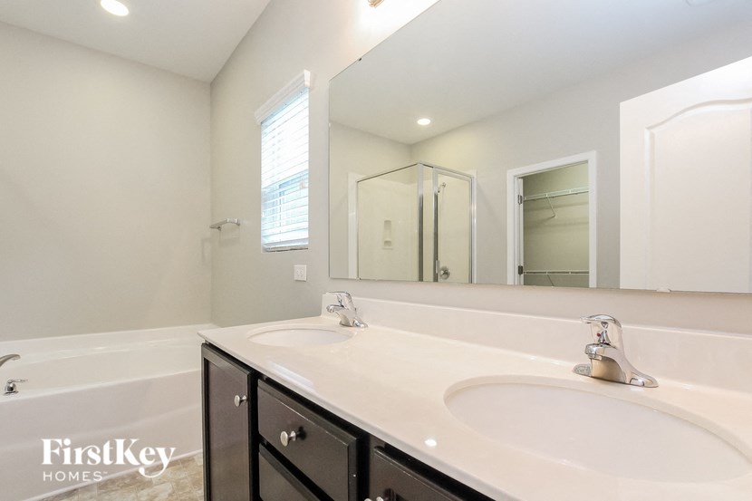 A bathroom with a white sink and a mirror.