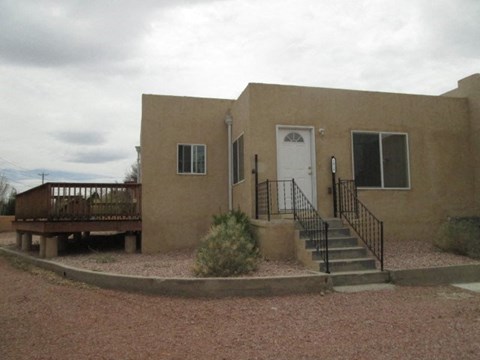 A house with a white door and a balcony.
