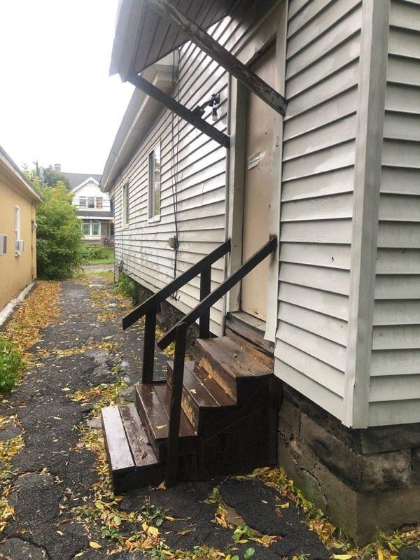 the side of a house with wooden steps up to it