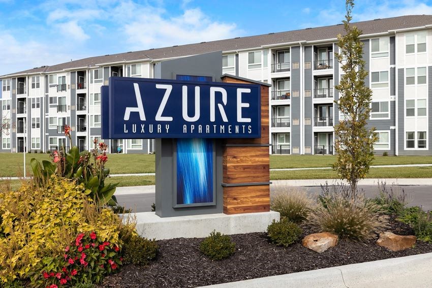 an apartment building with a sign for azone luxury apartments