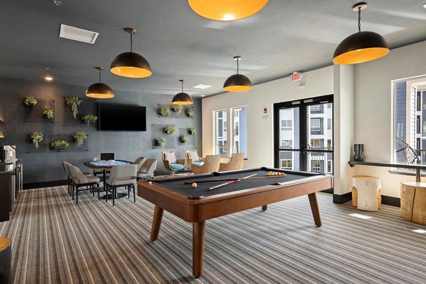 a clubhouse with a pool table and a tv