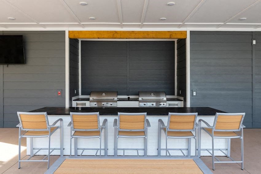 a kitchen with a bar with chairs in front of it