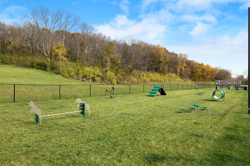 a park with a playground and a fence