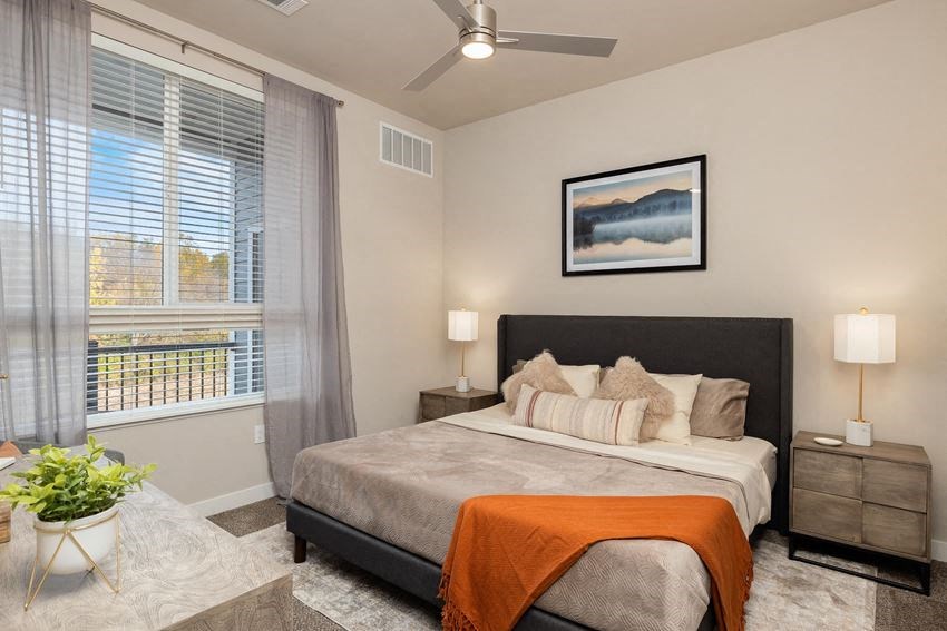 a bedroom with a bed and a ceiling fan