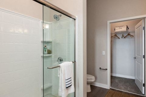 a bathroom with a glass shower and a toilet