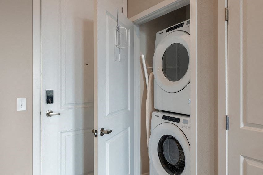 a washer and dryer in a closet with a door