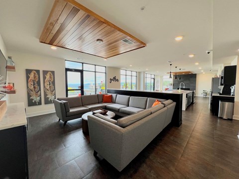 a living room with couches and a kitchen
