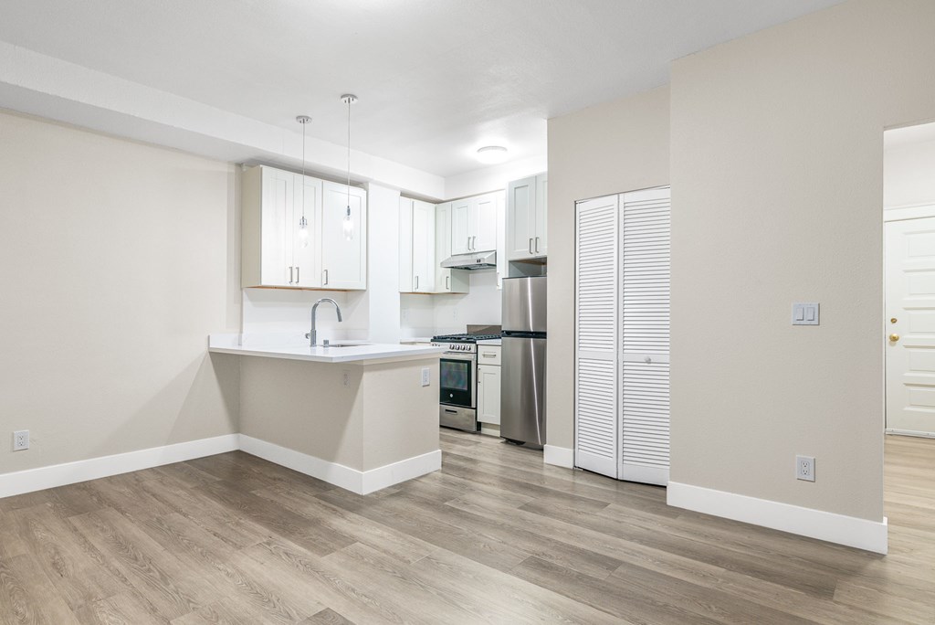 a renovated kitchen with white cabinets and a white counter top