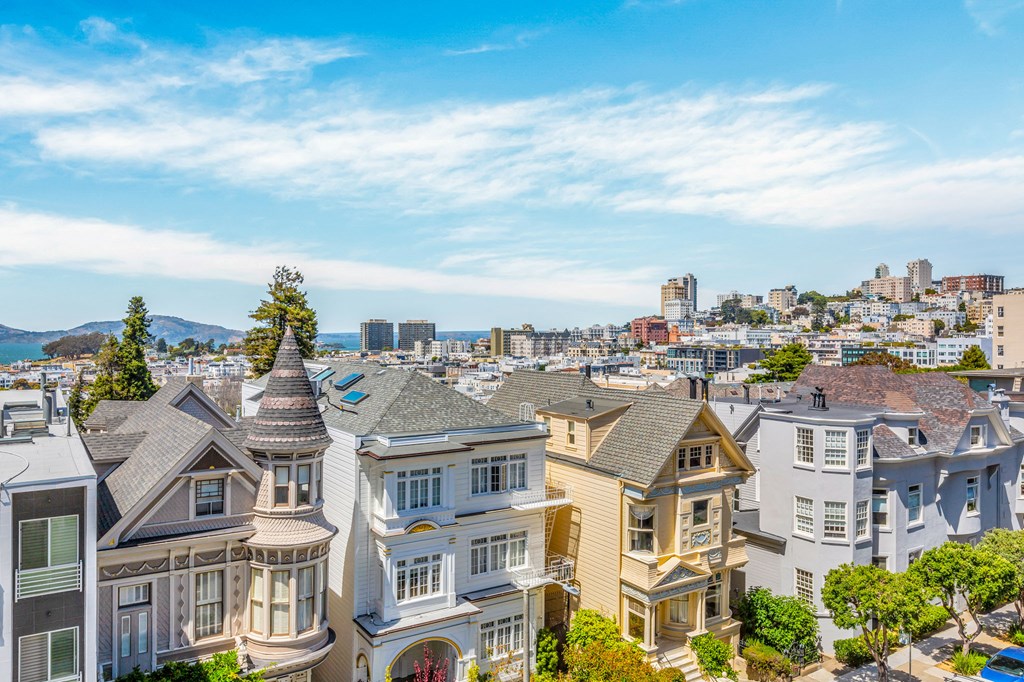 an aerial view homes with the city in the background