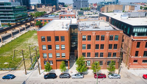 an aerial view of a large brick building in a city