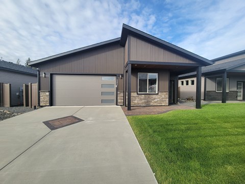 the front of a house with a driveway and a garage door