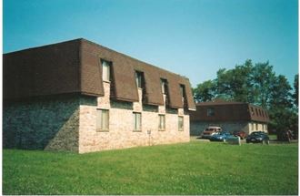 a large brick building with cars parked in front of it
