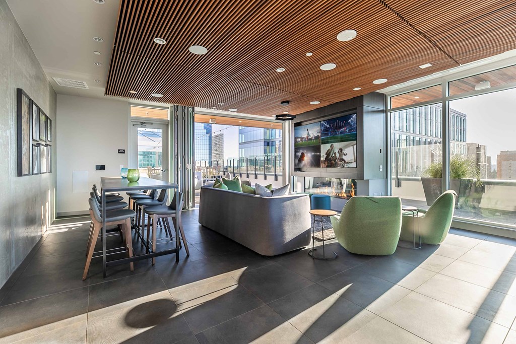 a lounge area with a couch chairs and a table