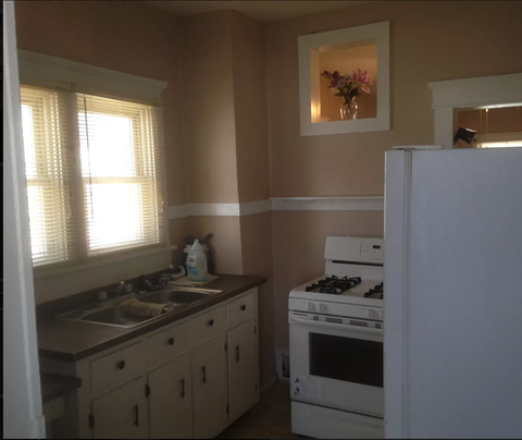 a kitchen with a stove and a sink and a refrigerator