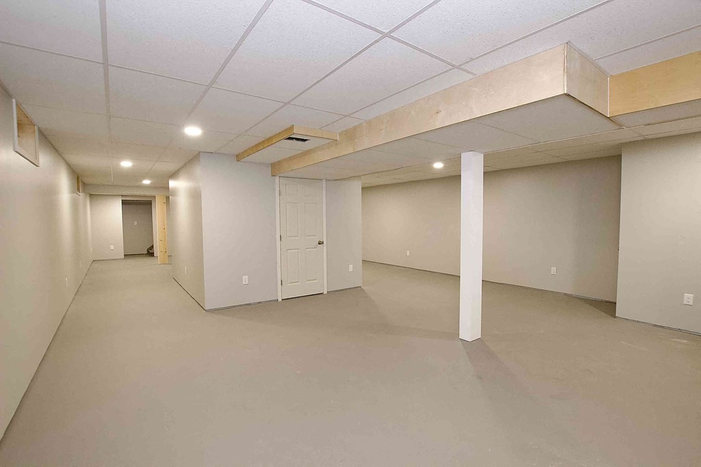 an empty room with white walls and ceilings and a white door