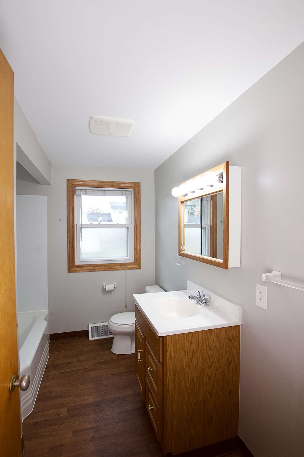 a bathroom with a sink toilet and a mirror