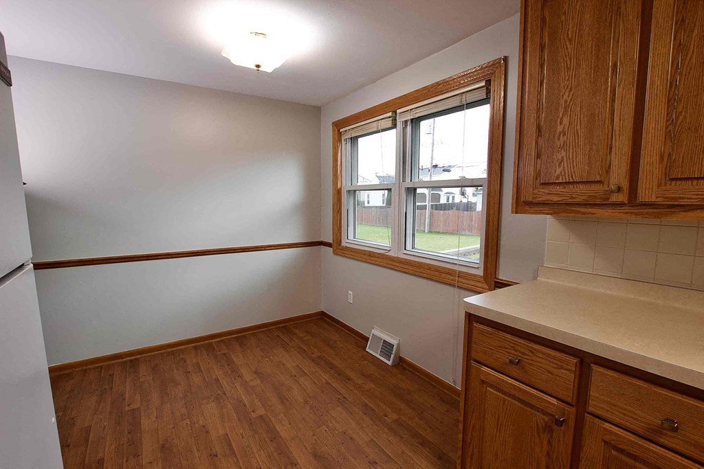 a kitchen with wood flooring and a window