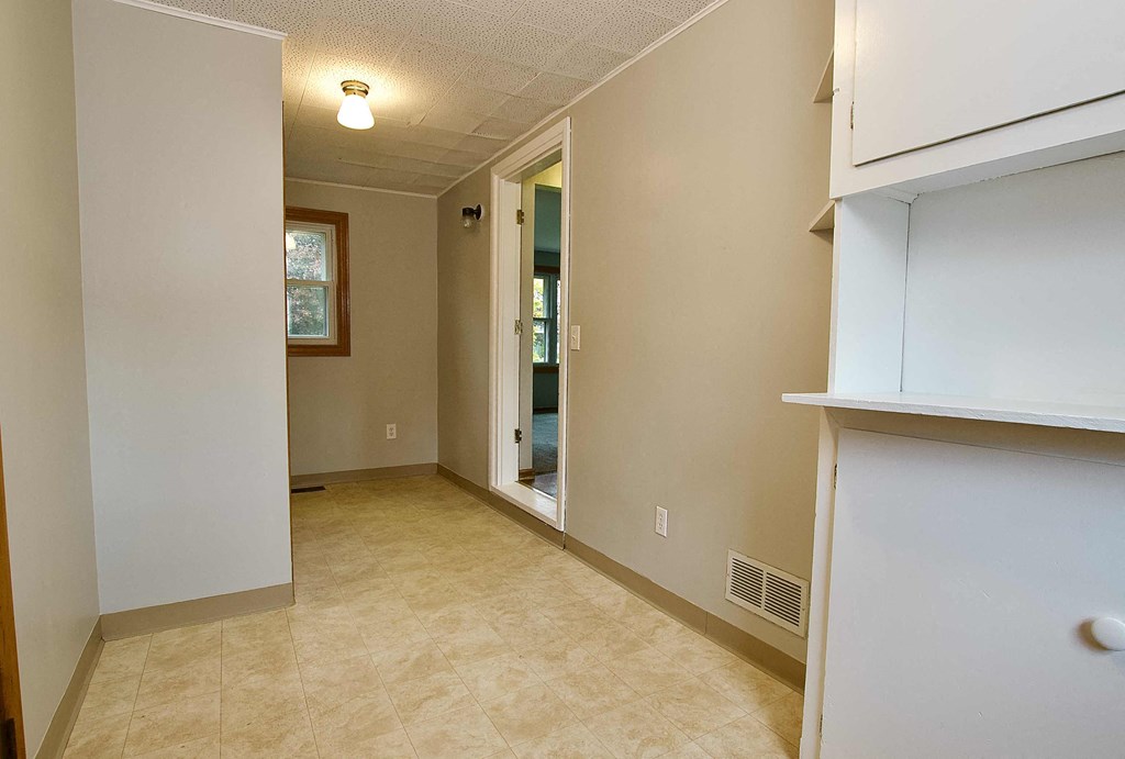 a room with a hallway and a door to a bathroom