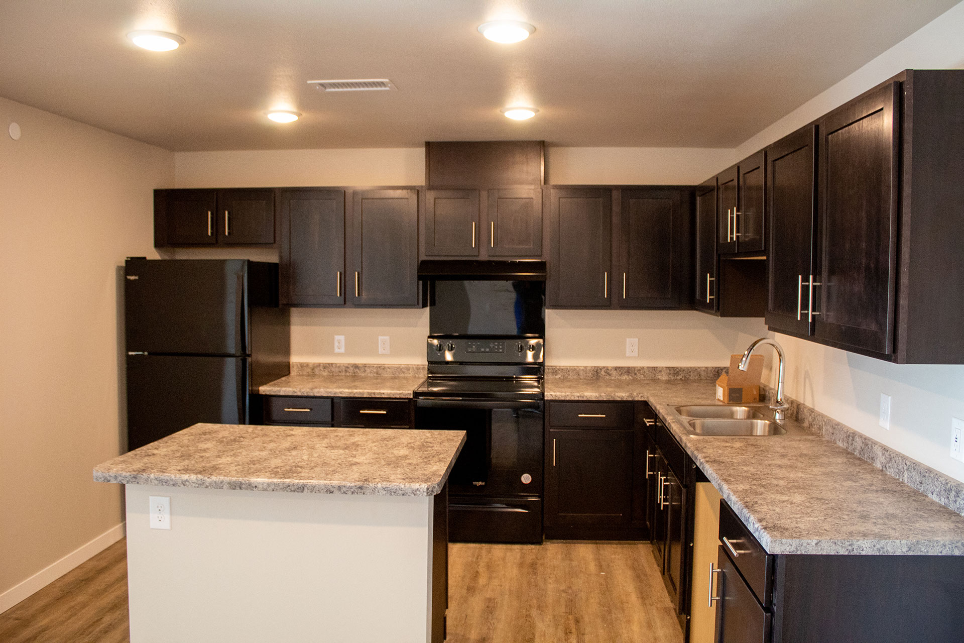 a kitchen with black appliances and granite counter tops