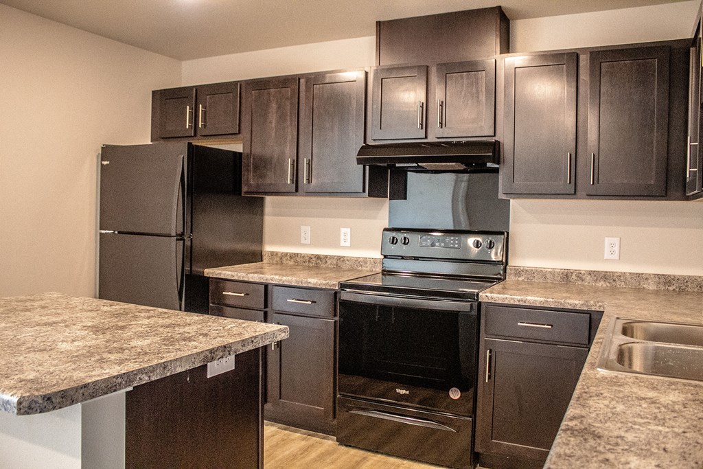 a kitchen with stainless steel appliances and granite counters