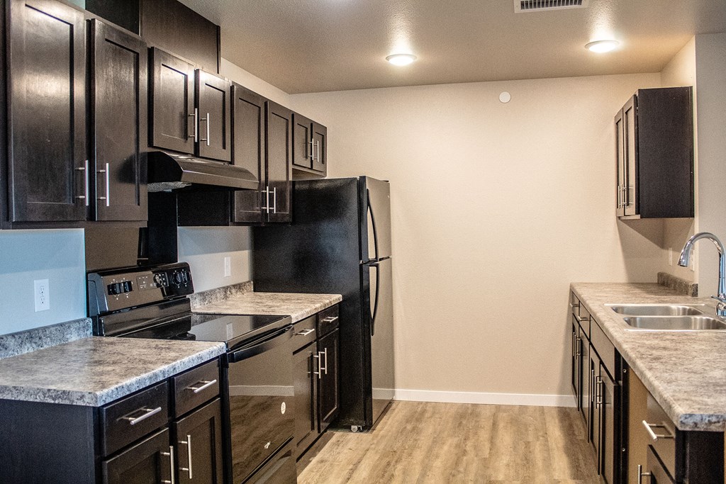 a kitchen with stainless steel appliances and marble counter tops