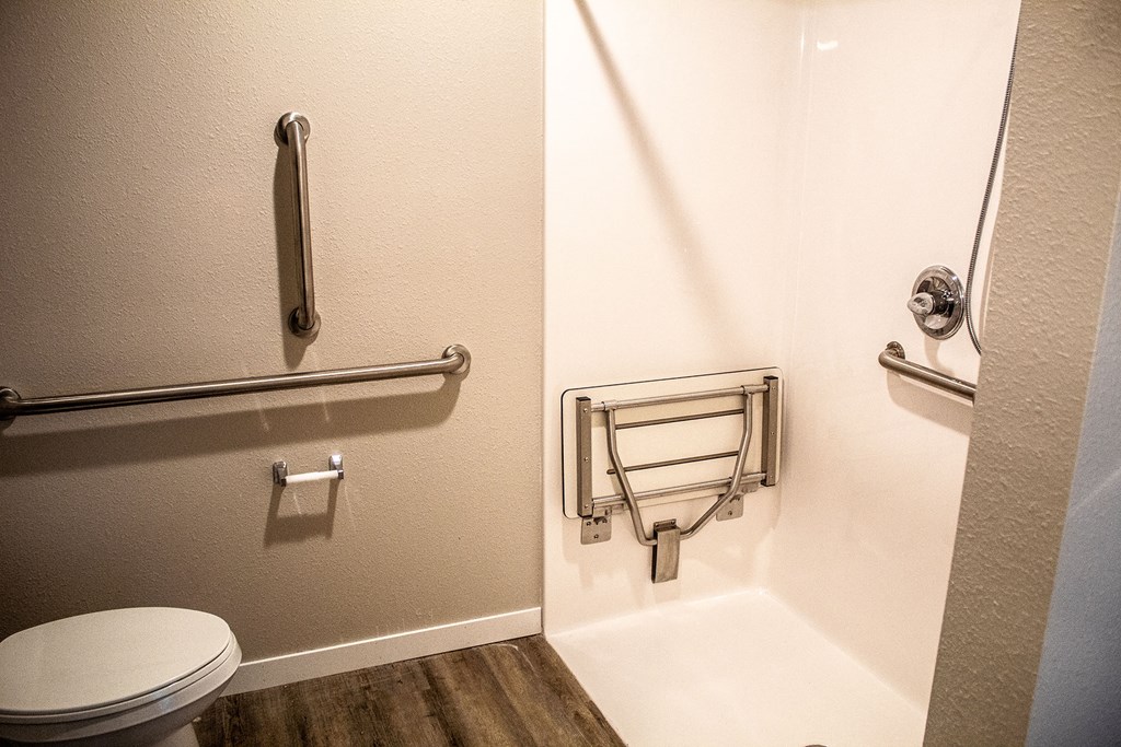 a bathroom with a toilet and a roll of toilet paper