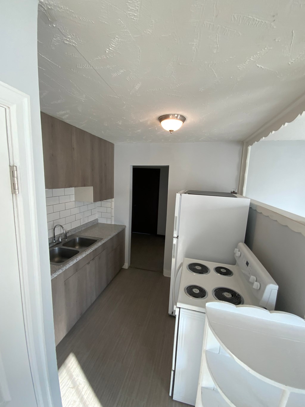 A small kitchen with a stove and sink.
