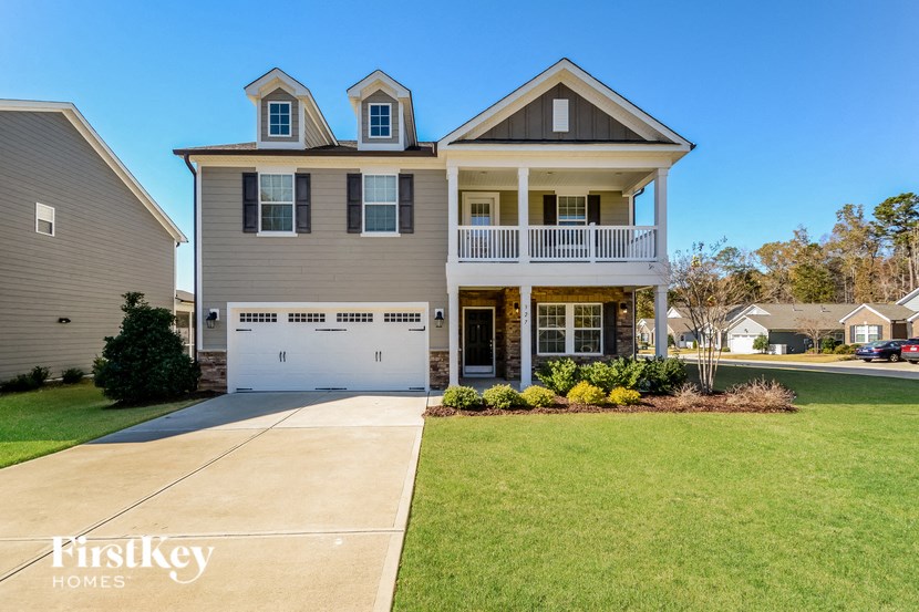 a large house with a sidewalk in front of it