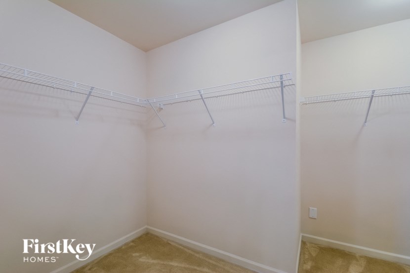 a empty closet with shelves in a white room