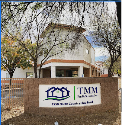 A sign for TMM Family Services, Inc. in front of a building.